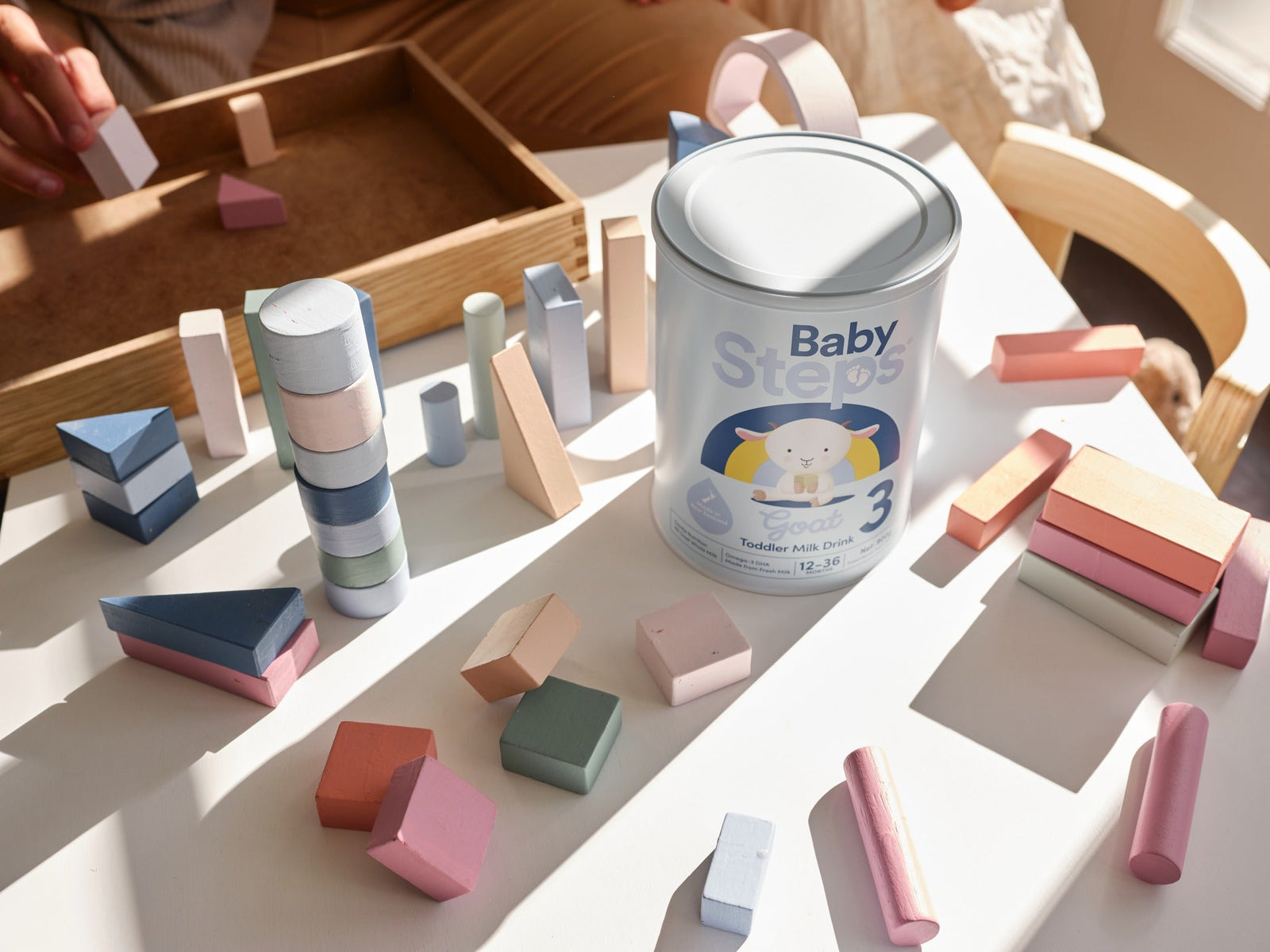 Close-up of a bottle of goat milk formula on a desk.