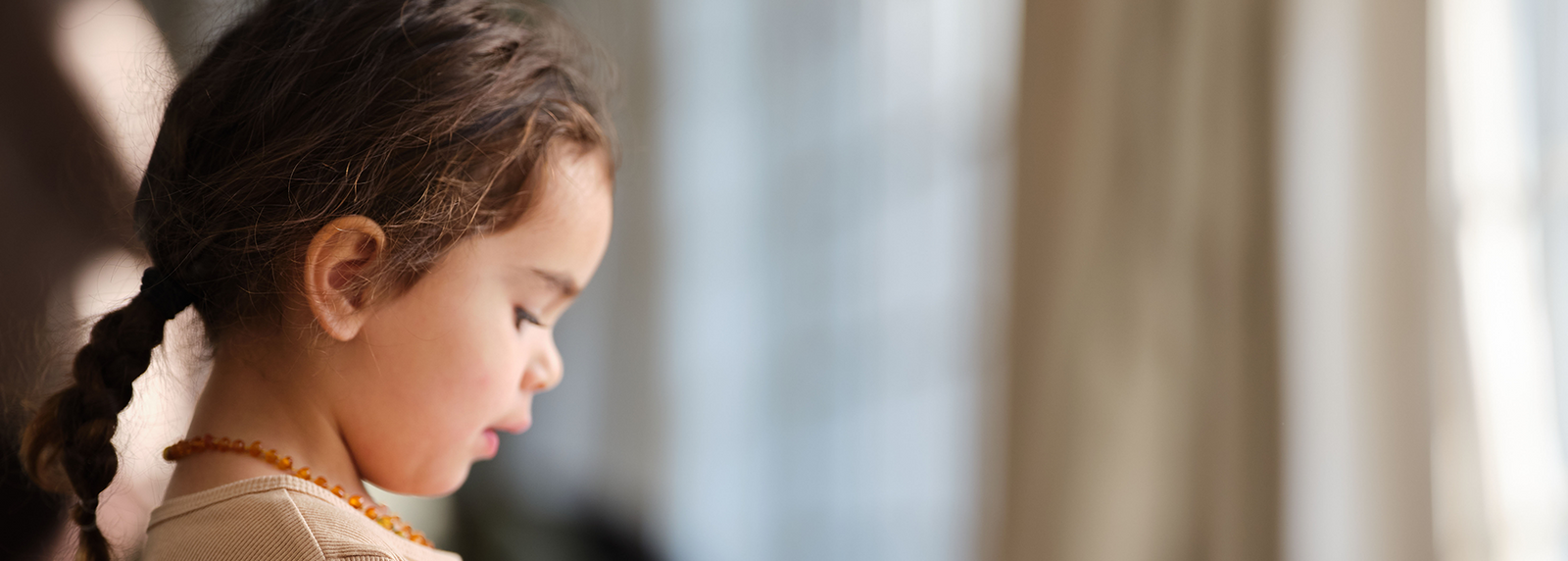 Toddler looking down playing with toys.