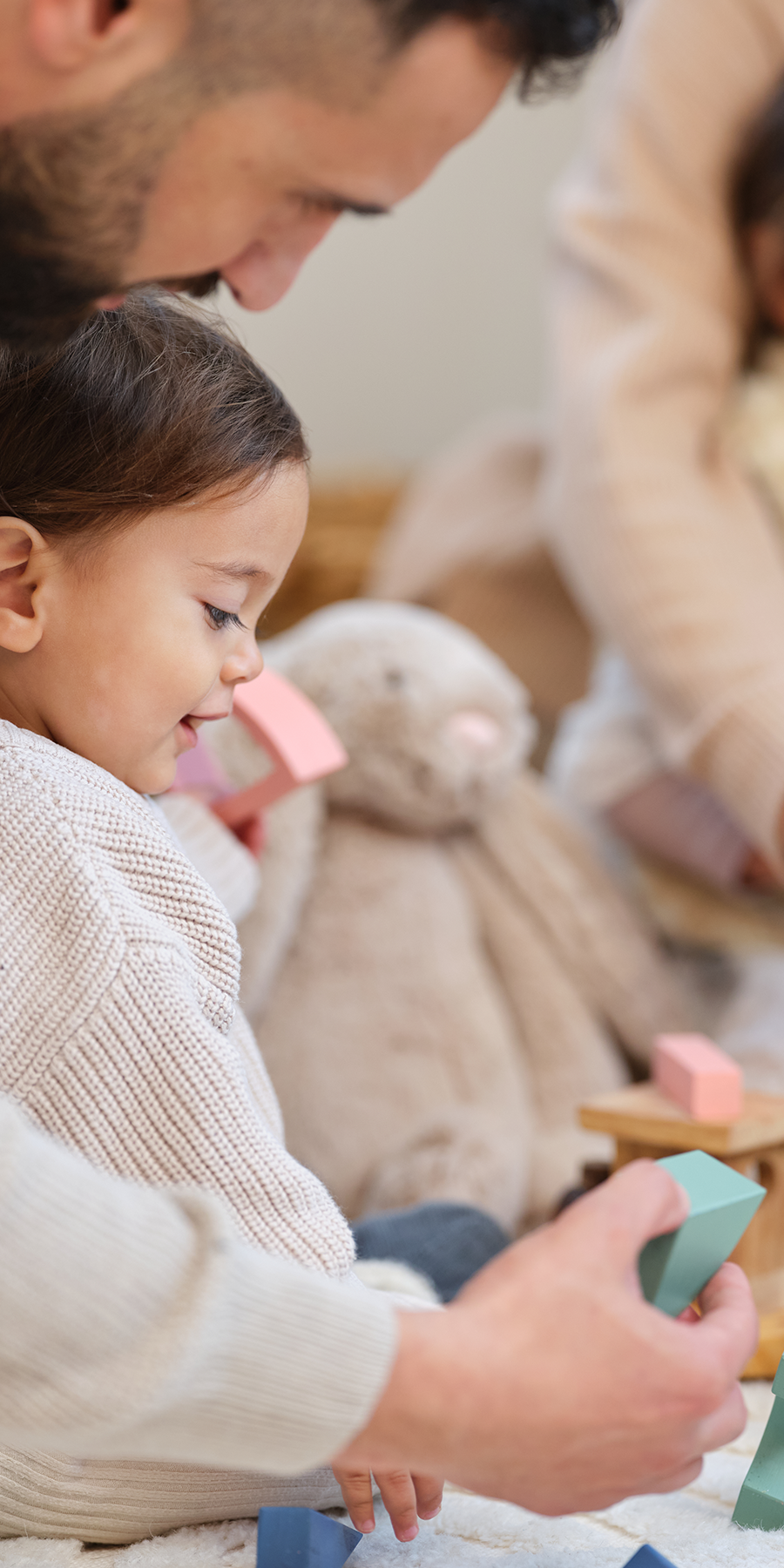 Toddler playing with Baby Steps coloured wooden blocks.